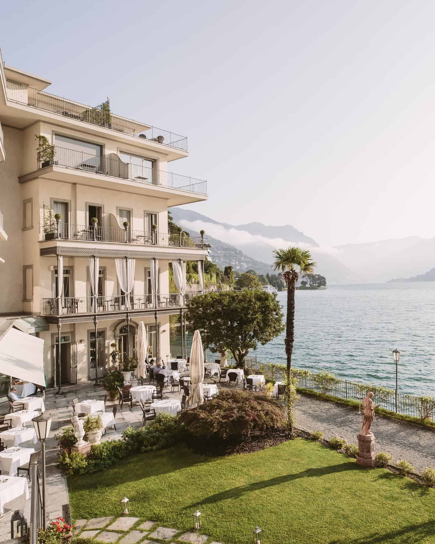 Edificio del hotel Villa Flori con jardín y mesas junto al lago de como en Italia 